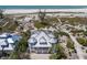 Aerial view of luxury home near the beach featuring lush landscape, private walkways, and beach access at 17 Seawatch Dr, Boca Grande, FL 33921