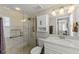 Bathroom featuring marble tile walls, a glass enclosed shower and a vanity with white cabinets at 17 Seawatch Dr, Boca Grande, FL 33921