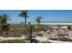 Panoramic view of the beach with a beautiful landscape filled with Palm Trees and ocean view at 17 Seawatch Dr, Boca Grande, FL 33921