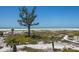 Elevated view of a pristine white sand beach and lush tropical vegetation under a clear blue sky at 17 Seawatch Dr, Boca Grande, FL 33921