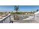 Scenic deck view with lush greenery and sandy beach with beautiful turquoise water in the background at 17 Seawatch Dr, Boca Grande, FL 33921