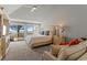 Comfortable bedroom boasting a plush bed, a cozy sitting area, and glass doors offering a view of the tranquil ocean at 17 Seawatch Dr, Boca Grande, FL 33921