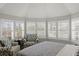 Bedroom featuring a vaulted ceiling, a bay window with white shutters and patterned chairs at 17 Seawatch Dr, Boca Grande, FL 33921