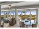 Bright dining area with beach views through large windows and comfortable seating at 17 Seawatch Dr, Boca Grande, FL 33921