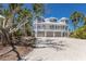 Spacious beach house boasting a large driveway, balcony, meticulous landscaping, and multi-car garage at 17 Seawatch Dr, Boca Grande, FL 33921