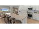 Open kitchen with breakfast bar, white cabinetry, and stainless steel appliances at 17 Seawatch Dr, Boca Grande, FL 33921