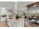 Bright, open-concept kitchen with white cabinets, marble countertops, and stainless steel appliances at 17 Seawatch Dr, Boca Grande, FL 33921