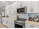 Close up of gourmet kitchen featuring modern appliances and stone countertops at 17 Seawatch Dr, Boca Grande, FL 33921