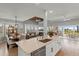 Modern kitchen with a large island, stainless steel appliances, and an open view to the living area and ocean view at 17 Seawatch Dr, Boca Grande, FL 33921