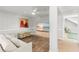 Cozy living room with wainscoting, comfortable seating, and a large flat-screen TV showing a beach scene at 17 Seawatch Dr, Boca Grande, FL 33921