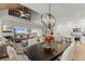 Open-concept living area featuring a dining table, a fireplace, and beautiful ocean views at 17 Seawatch Dr, Boca Grande, FL 33921
