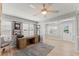 Bright office space featuring a ceiling fan, neutral walls, shutters and a wooden desk at 17 Seawatch Dr, Boca Grande, FL 33921