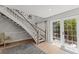 Bright foyer features a staircase with wooden handrail and natural light at 17 Seawatch Dr, Boca Grande, FL 33921