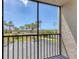 View from the screened in balcony overlooks lush green landscaping and ample parking at 1701 Beach Rd # 208, Englewood, FL 34223