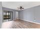 Spacious bedroom with sliding glass door leading to outdoor area and ceiling fan at 1701 Beach Rd # 208, Englewood, FL 34223