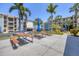 Outdoor common area with picnic tables, umbrellas, and ample parking for residents and guests at 1701 Beach Rd # 208, Englewood, FL 34223