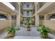 Charming courtyard with lush greenery, a decorative fountain, and cozy seating areas at 1701 Beach Rd # 208, Englewood, FL 34223