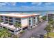 Close exterior of a waterfront condo featuring covered parking and a beautiful orange tile roof at 1701 Beach Rd # 208, Englewood, FL 34223