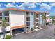 Exterior of condo features covered parking, private balconies, and light blue accents at 1701 Beach Rd # 208, Englewood, FL 34223
