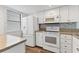Efficient kitchen featuring stainless steel appliances, plenty of counter space, and wood-look flooring at 1701 Beach Rd # 208, Englewood, FL 34223