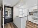 Bright, updated kitchen with white appliances, breakfast bar and wood flooring at 1701 Beach Rd # 208, Englewood, FL 34223