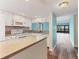 Modern kitchen with breakfast bar, mosaic backsplash, and stainless steel appliances at 1701 Beach Rd # 208, Englewood, FL 34223