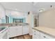 Well-equipped kitchen with white appliances, mosaic backsplash, and easy access to the living area at 1701 Beach Rd # 208, Englewood, FL 34223