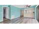 Spacious living room featuring vinyl plank flooring and open access to the kitchen at 1701 Beach Rd # 208, Englewood, FL 34223