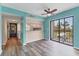 Bright living area featuring plank flooring, a ceiling fan, and access to both the kitchen and the screened patio at 1701 Beach Rd # 208, Englewood, FL 34223