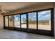 Bright living room with tile floors and sliding glass doors to patio at 1701 Beach Rd # 208, Englewood, FL 34223