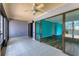 Living room with tile floors, ceiling fan, and sliding glass doors leading to outdoor view at 1701 Beach Rd # 208, Englewood, FL 34223