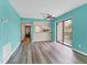 Well-lit living room with sleek floors, a ceiling fan, and sliding door access to the outdoor patio at 1701 Beach Rd # 208, Englewood, FL 34223