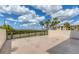 Large patio with views of lush greenery and palm trees, creating a serene outdoor space at 1701 Beach Rd # 208, Englewood, FL 34223