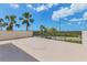 Expansive patio with a serene view of palm trees and lush greenery, offering a relaxing outdoor retreat at 1701 Beach Rd # 208, Englewood, FL 34223