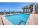 Relaxing community pool with clear blue water and comfortable seating, overlooking the bay at 1701 Beach Rd # 208, Englewood, FL 34223
