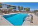 Sparkling community pool with lounge chairs and a tiki hut for shade and relaxation at 1701 Beach Rd # 208, Englewood, FL 34223