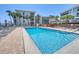 Inviting community pool with lounge chairs, sunny skies and manicured landscaping at 1701 Beach Rd # 208, Englewood, FL 34223