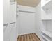 Walk-in closet featuring built-in shelving units and wooden laminate flooring at 1701 Beach Rd # 208, Englewood, FL 34223