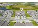 Aerial view of community showing a group of townhomes with driveways and lush landscaping at 17645 Boracay Ct # 202, Venice, FL 34293
