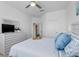 Comfortable bedroom featuring a ceiling fan and soft, plush bedding at 17645 Boracay Ct # 202, Venice, FL 34293