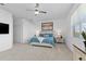 Bright bedroom features neutral carpet, a ceiling fan, and a large window at 17645 Boracay Ct # 202, Venice, FL 34293