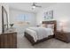 Bright bedroom with wooden furniture, neutral walls, and a ceiling fan for added comfort at 17645 Boracay Ct # 202, Venice, FL 34293