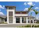 The Wellen Park Pro Shop is a modern building accented by palm trees and a blue sky at 17645 Boracay Ct # 202, Venice, FL 34293