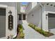 Exterior view of the front of the home and entry showing a walkway leading to the front door at 17645 Boracay Ct # 202, Venice, FL 34293