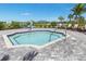 Inviting community hot tub with a lift chair and comfortable seating area at 17645 Boracay Ct # 202, Venice, FL 34293