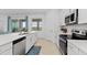 Bright kitchen features stainless appliances, white cabinets, and a large island at 17645 Boracay Ct # 202, Venice, FL 34293