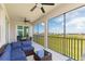 Spacious screened lanai with seating, ceiling fans, and views of the lush landscape at 17645 Boracay Ct # 202, Venice, FL 34293