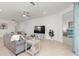 Large living room features modern decor, tiled floors, an open layout and a view into the bedroom at 17645 Boracay Ct # 202, Venice, FL 34293