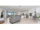 Open-concept living room with sliding glass doors leading to a patio, and well-equipped kitchen at 17645 Boracay Ct # 202, Venice, FL 34293