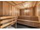 Relaxing wooden sauna with bench seating and soft lighting for a spa-like experience at 17645 Boracay Ct # 202, Venice, FL 34293